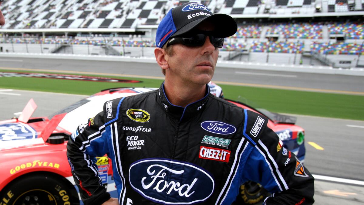 NASCAR driver Greg Biffle watches the scoreboard Friday only moments before it registered that he had won the pole for the Coke Zero 400.