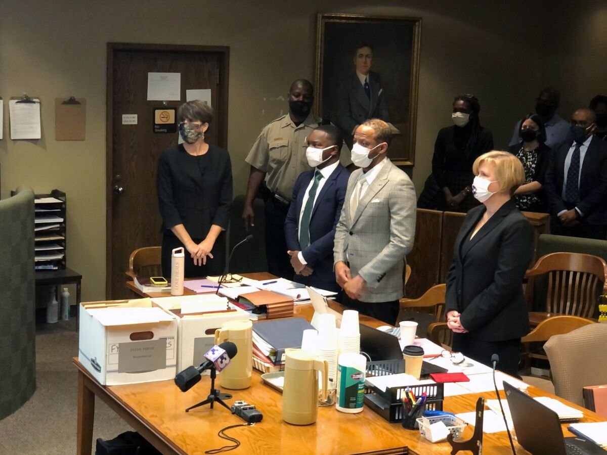 Former death row inmate Pervis Payne, at table, second from right, stands as a judge enters a courtroom, Monday, Dec. 13, 2021, in Memphis, Tenn. Payne faces two terms of life in prison after his death sentence was vacated when he was found to be intellectually disabled by court experts. (AP Photo/Adrian Sainz)