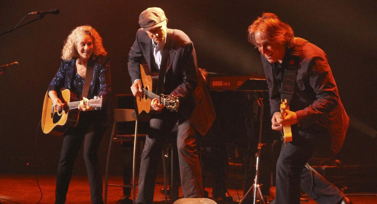 Carole King, James Taylor and Danny Kortchmar perform onstage.