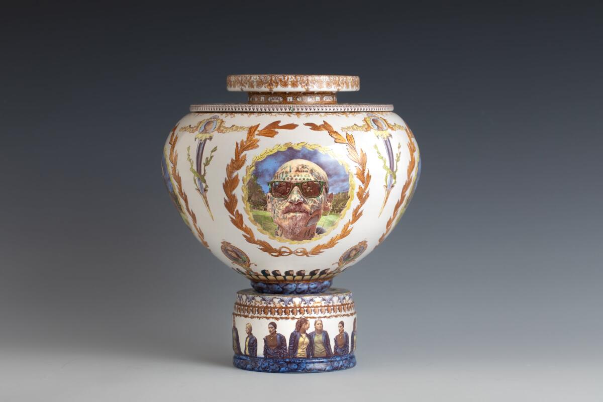 A hand-thrown urn in the form of classic Greek pottery is painted with the images of a guy with sunglasses and face tattoos.