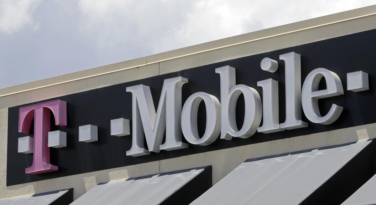 FILE - This photo taken Thursday, July 27, 2017, shows T Mobile sign at a store in Hialeah, Fla. T- Mobile has agreed to pay $350 million, Friday, July 22, 2022, to customers affected by a class action lawsuit filed after the company disclosed last August that personal data like social security numbers had been stolen in a cyberattack.(AP Photo/Alan Diaz, File)