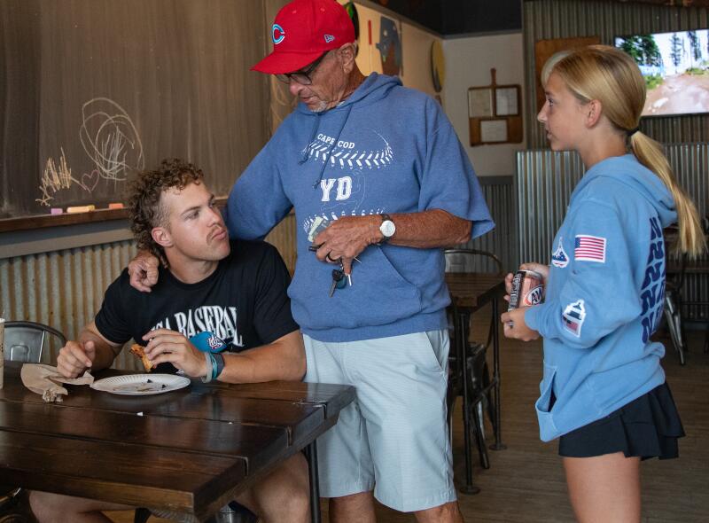 Scott Pickler talks to a player after morning activities at lunch.