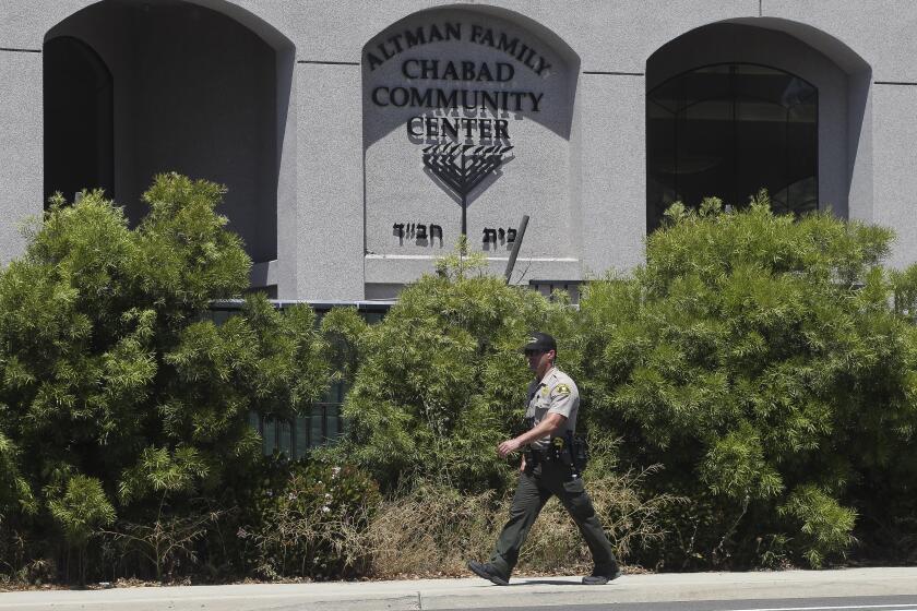 Hayne Palmour IV   U-T A sheriff’s deputy patrols in front of the Altman Family Chabad Community Center in Poway soon after an armed man shot multiple people inside the community center, killing a woman, in April.