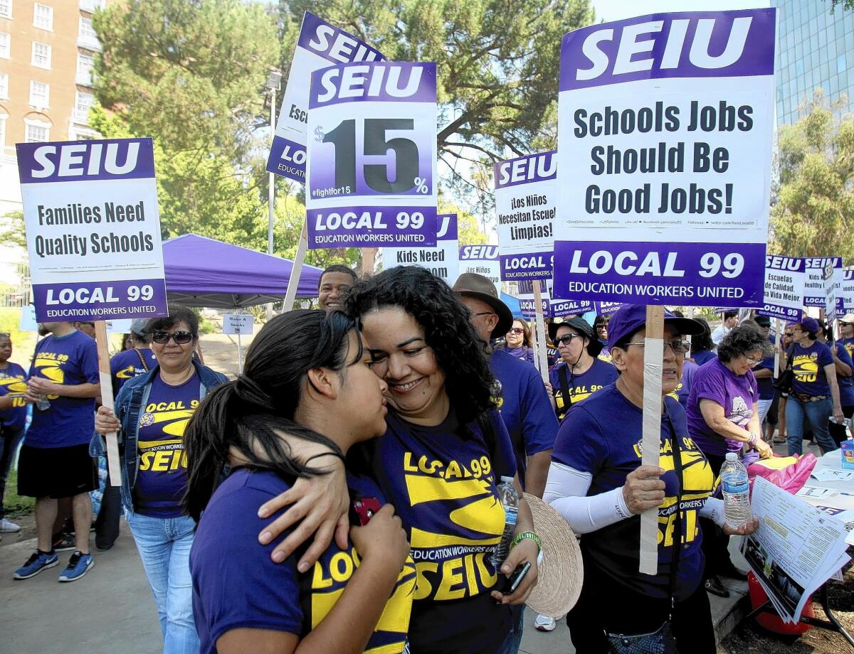 Juanita Turcios, a preschool teachers assistant, and daughter Nelcie rally in May for the $15 minimum wage that Los Angeles Unified School District board members just agreed to unanimously.