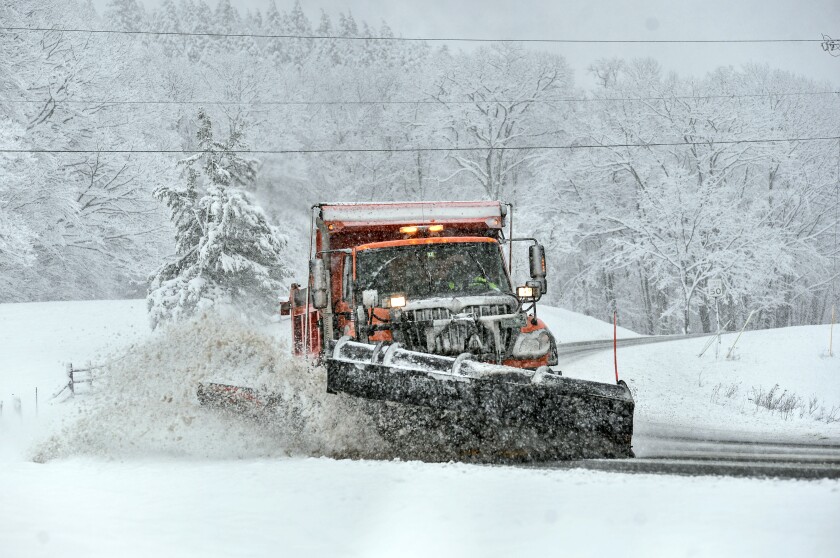 A snowplow clears the snow from Route 9, in Marlboro, Vt., as several inches of snow falls on Friday, April 16, 2021. (Kristopher Radder/The Brattleboro Reformer via AP)
