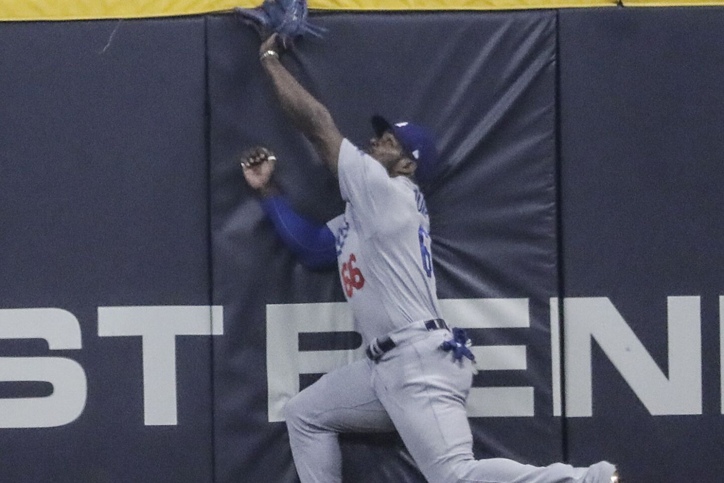 Yasiel Puig can’t reach a first inning homer by Christian Yelich.