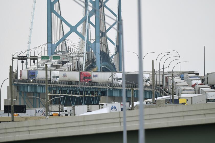 COVID-19 truck blockade in Canada shuts down Ford plant - Los Angeles Times