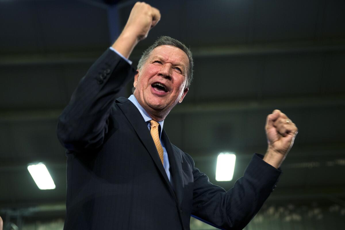 Republican presidential candidate and Ohio Gov. John Kasich gestures at his primary election rally in Berea, Ohio.