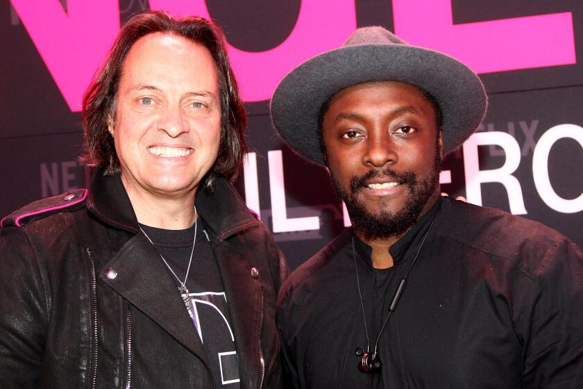 John Legere, left, president and CEO of T-Mobile, and singer-songwriter will.i.am attend launch event for T-Mobile's "Binge On" unlimited video streaming service.