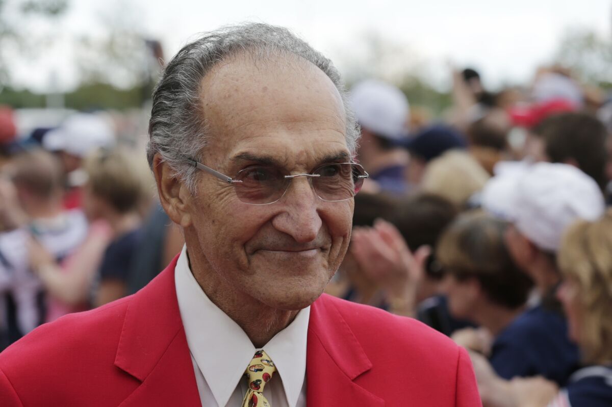 FILE -Former New England Patriot Gino Cappelletti outside the Patriot's Hall of Fame prior to an NFL football training camp in Foxborough, Mass., Wednesday, Aug. 5, 2015. Gino Cappelletti, a former AFL Most Valuable Player and original member of the Boston Patriots who was part of the franchise for five decades as a player, coach and broadcaster, has died. He was 89. Cappelletti died at his home in Wellesley, Massachusetts. His death was announced by the New England Patriots on Thursday, May 12, 2022 No cause of death was given. (AP Photo/Charles Krupa, File)