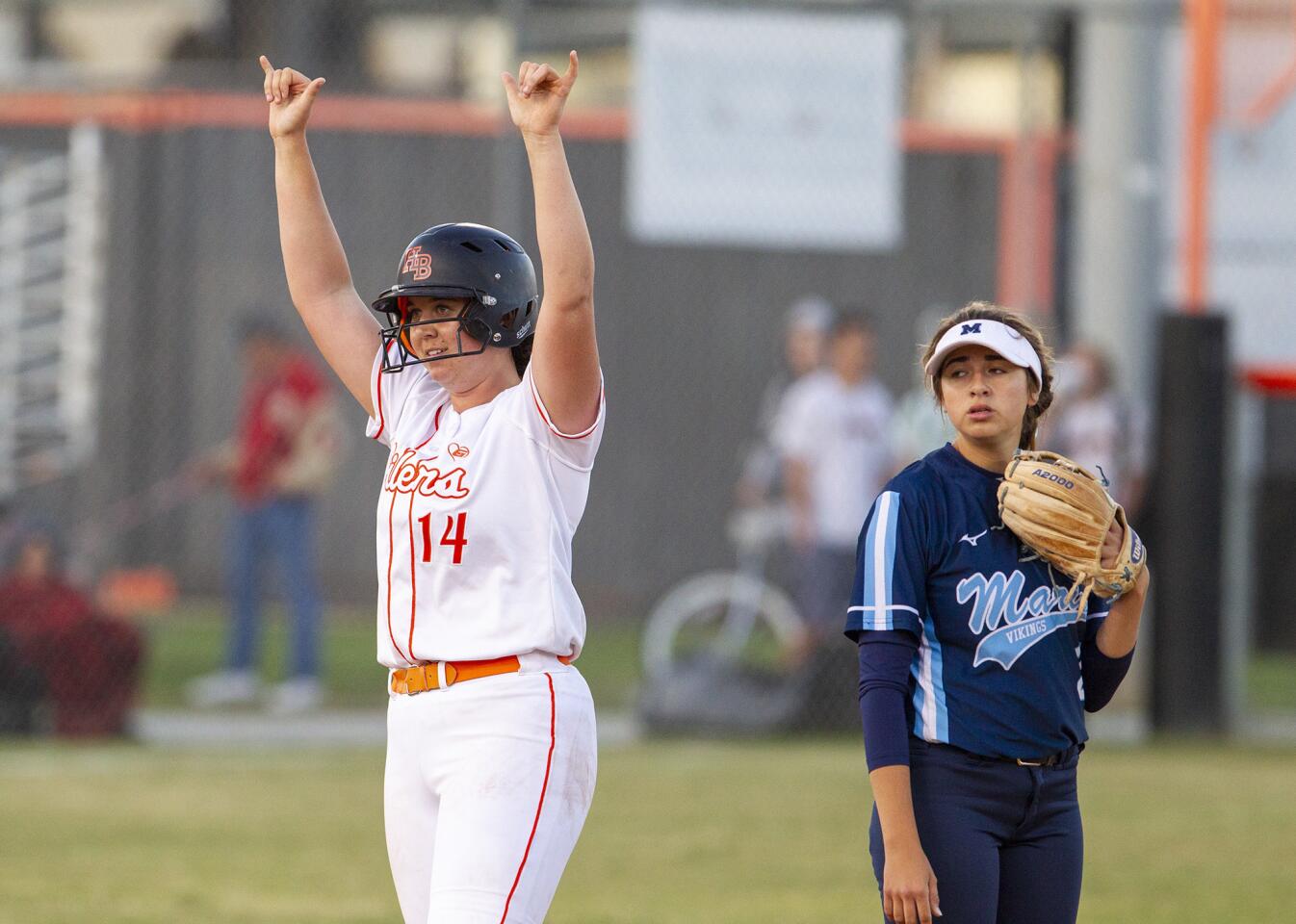 Huntington Beach High's Reanna Rudd gestures to the dugout after hitting an RBI double in the fourth inning of a Surf League game against Marina at Huntington Beach on Tuesday.