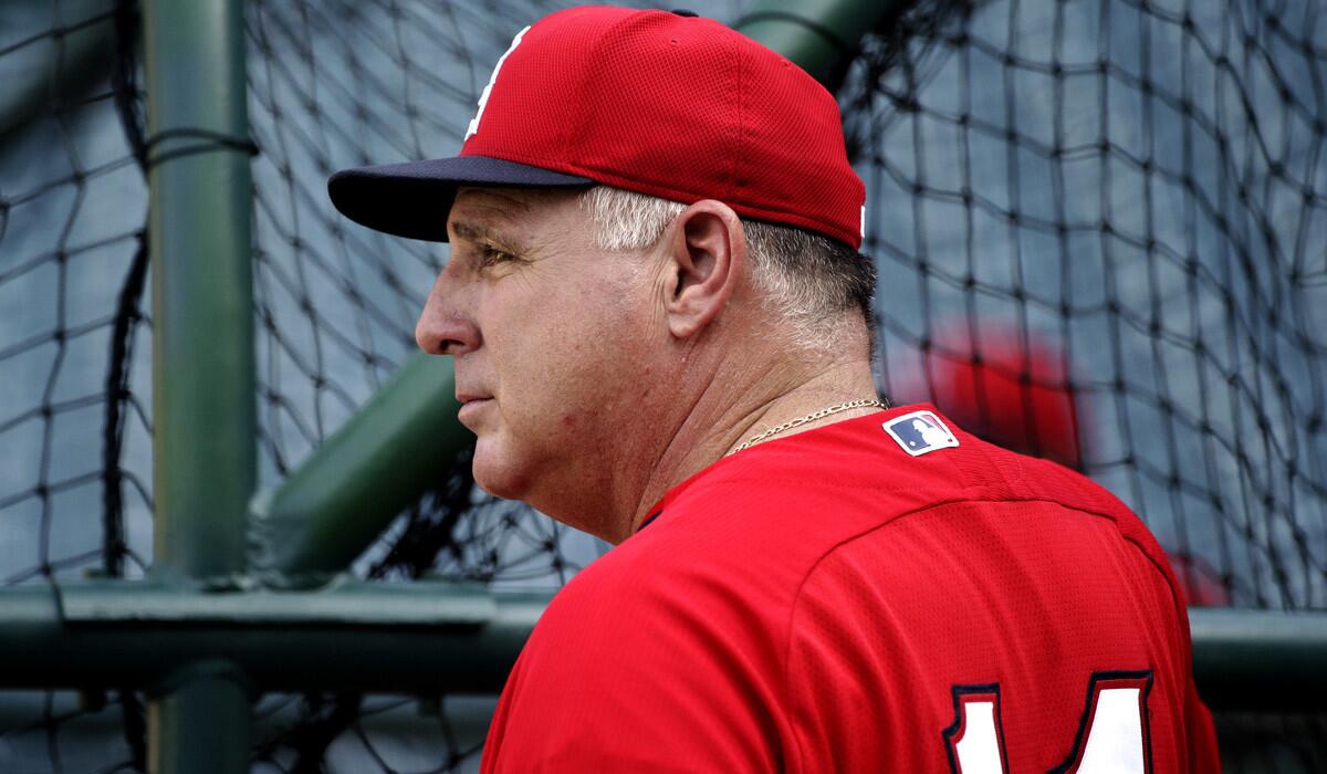 Angels Manager Mike Scioscia watches as his players take batting practice before a game against the Astros on Saturday in Anaheim.