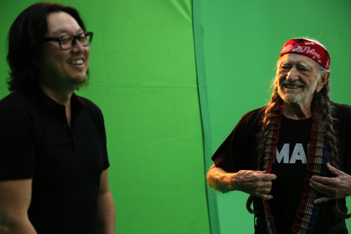 Director Joseph Kahn, left, with Willie Nelson during the taping of Nelson's part in the all-star video "Forever Country."