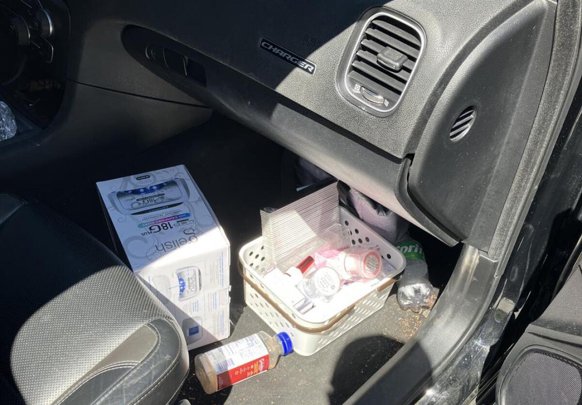 Merchandise in a basket in front of the passenger seat inside a car