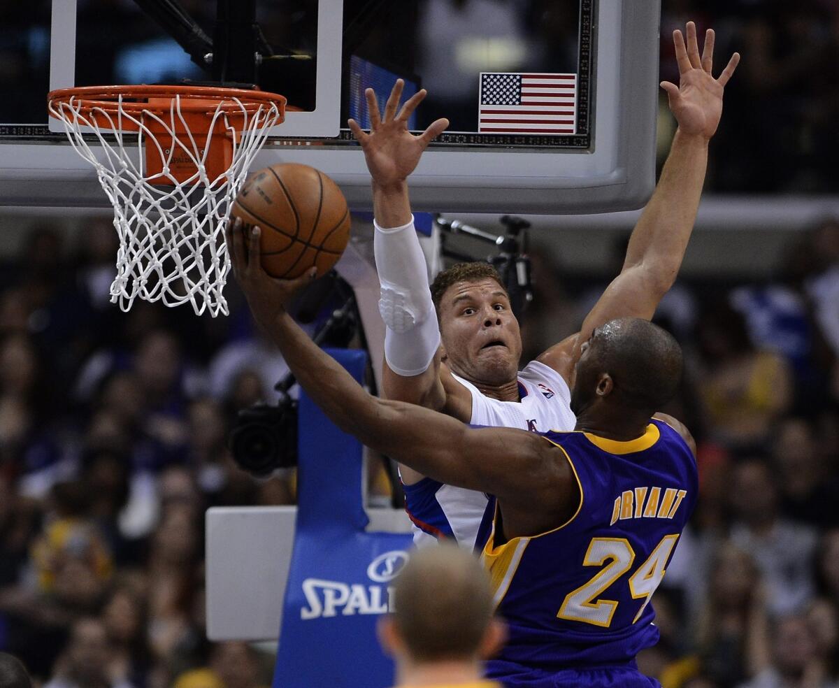 The Clippers' Blake Griffin challenges a shot by the Lakers' Kobe Bryant.