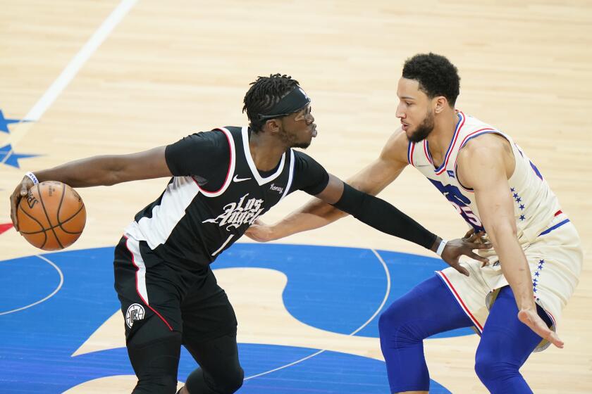 Los Angeles Clippers' Reggie Jackson, left, tries to get past Philadelphia 76ers' Ben Simmons during the first half of an NBA basketball game, Friday, April 16, 2021, in Philadelphia. (AP Photo/Matt Slocum)