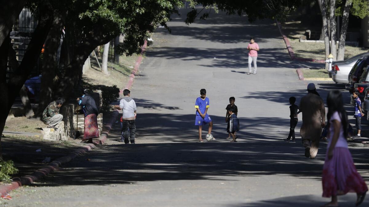 Children play outside the apartment complex where Thomas Eric Duncan, the Ebola patient who traveled from Liberia to Dallas, stayed.