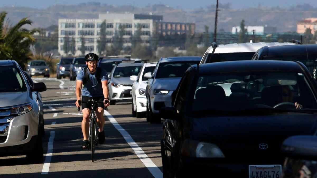 Tom Krenzke, 35, commutes to work through Playa del Rey on Thursday. "I used to ride elbow-to-elbow with cars," he said. "Now I have a whole lane to myself."