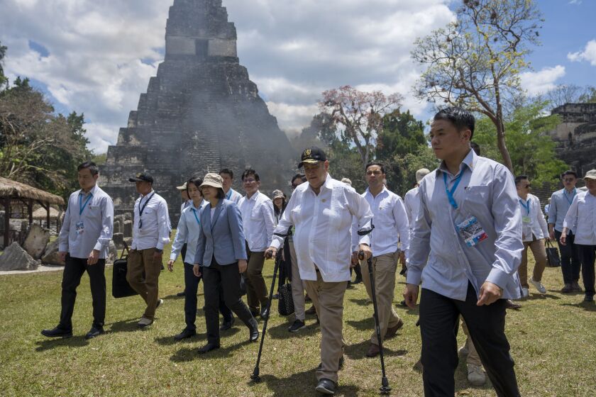 Taiwan's President Tsai Ing-wen, center left, and Guatemala's President Alejandro Giammattei, walk to a staging area during their visit to the Mayan site Tikal, in Peten, Guatemala, Saturday, April 1, 2023. Tsai is in Guatemala for an official three-day visit. (AP Photo/Moises Castillo)