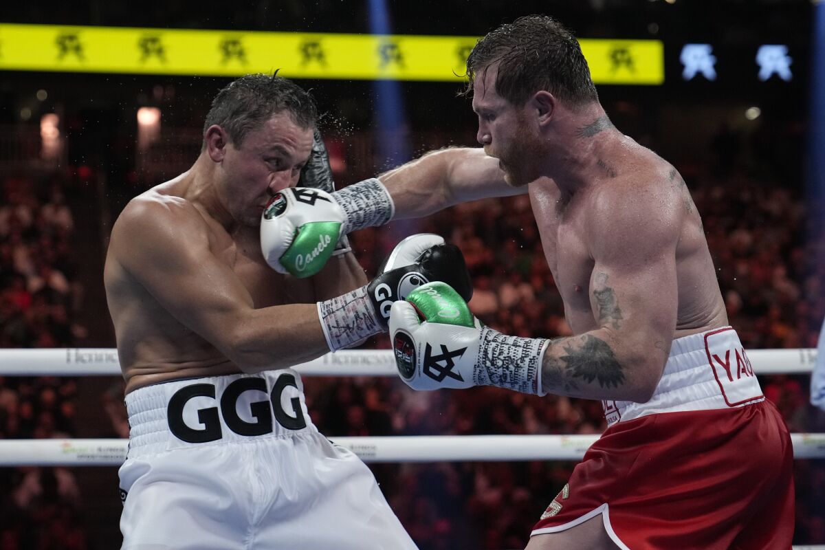 Canelo Álvarez connects in the face of Gennadiy Golovkin during their title fight.