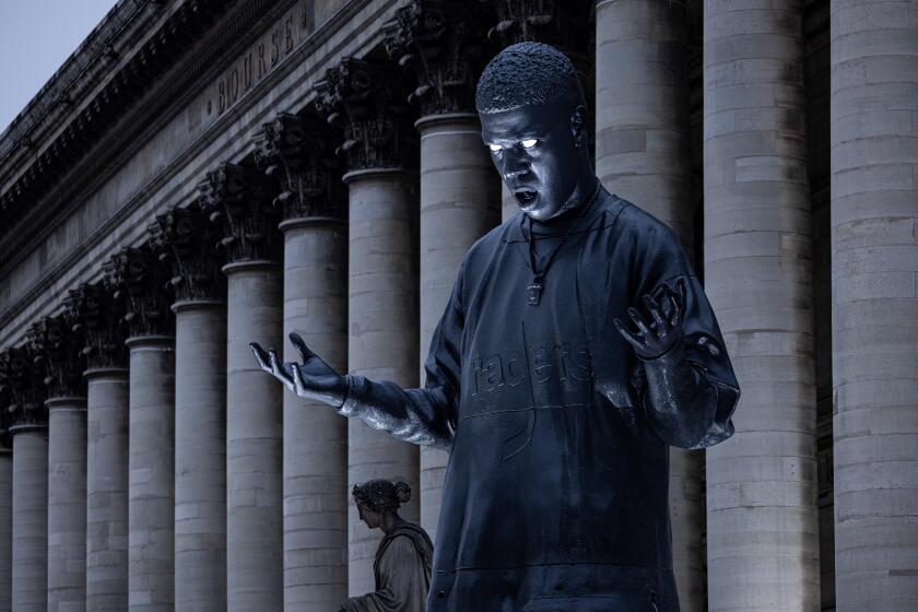 A 10-metre high statue depicting US rap singer and actor Scott Ramon Seguro Mescudi, aka Kid Cudi, is installed in front of the Palais Brongniart in Paris, on January 12, 2024, to mark the release of his new album "Insano". (Photo by JOEL SAGET / AFP) (Photo by JOEL SAGET/AFP via Getty Images)