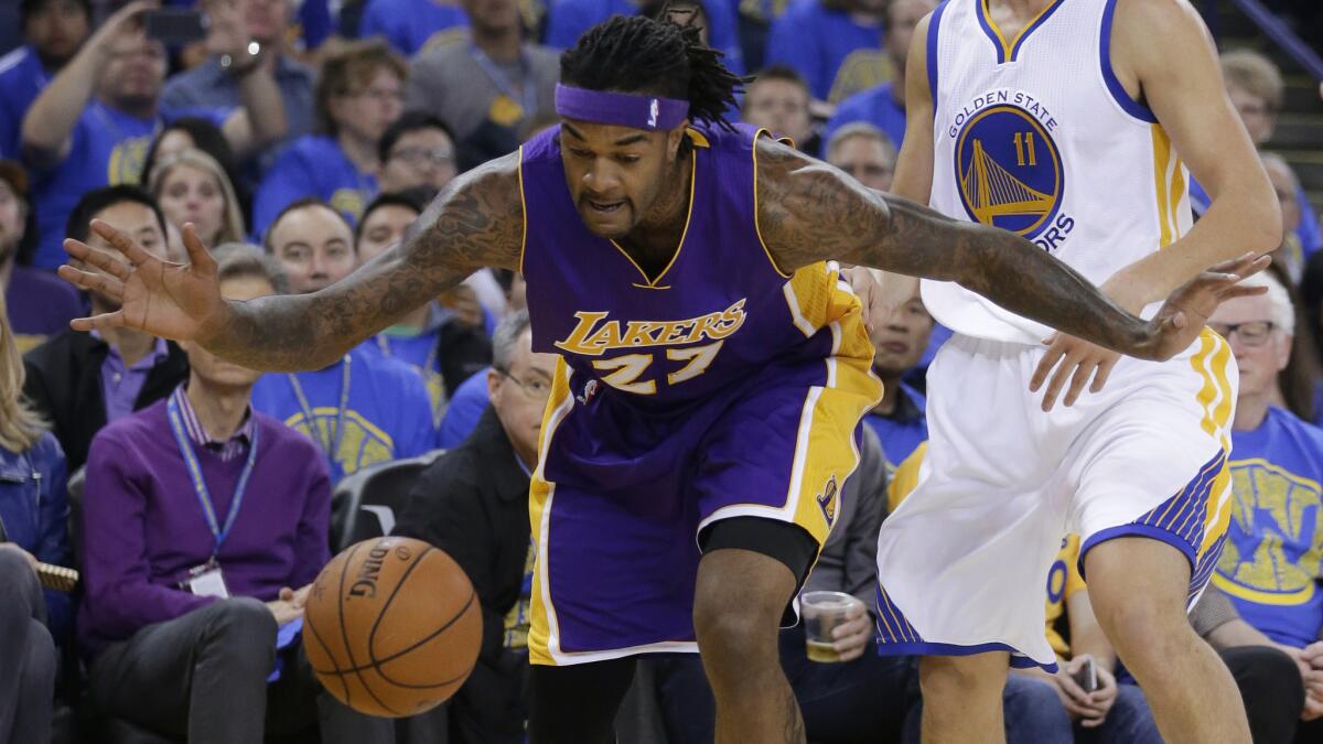 Lakers forward Jordan Hill watches as the ball bounces out of bounds during a loss to the Golden State Warriors on Saturday.