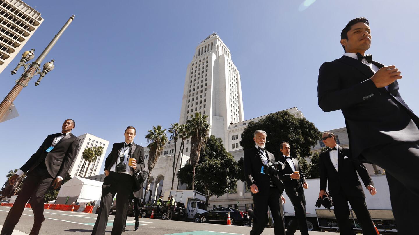 Extras cross Spring Street in downtown Los Angeles as the film "Ocean's Eight" is shooting scenes on the steps of Los Angeles City Hall on March 6, 2017. The film features female thieves who try to pull off the heist of the century at New York's annual Met Gala.