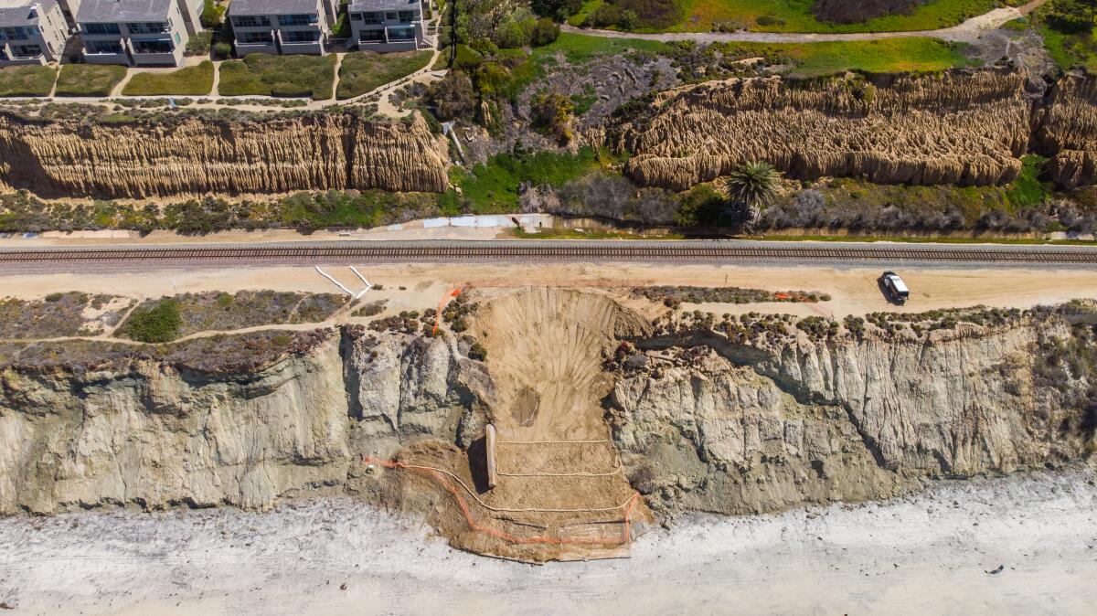Repairs continue this weekend at the site of a bluff collapse along the train tracks in Del Mar, shown March 19, 2021.