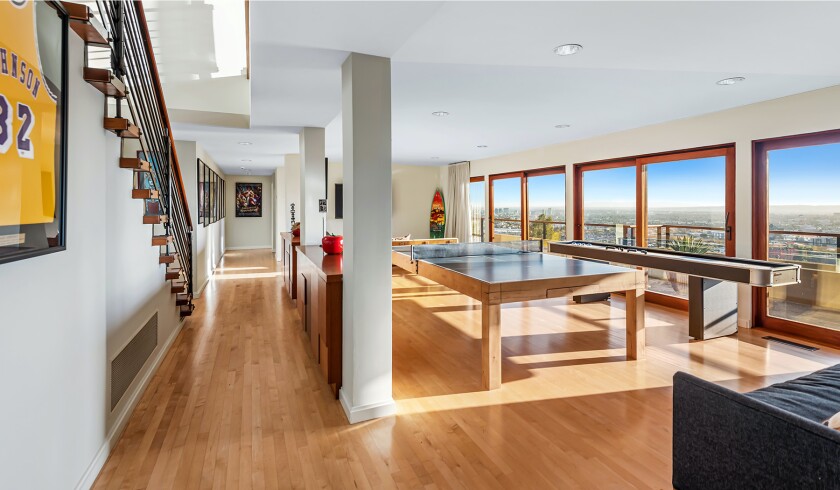 The hillside home includes three levels of decks, balconies and patios, as well as a swimming pool and spa.