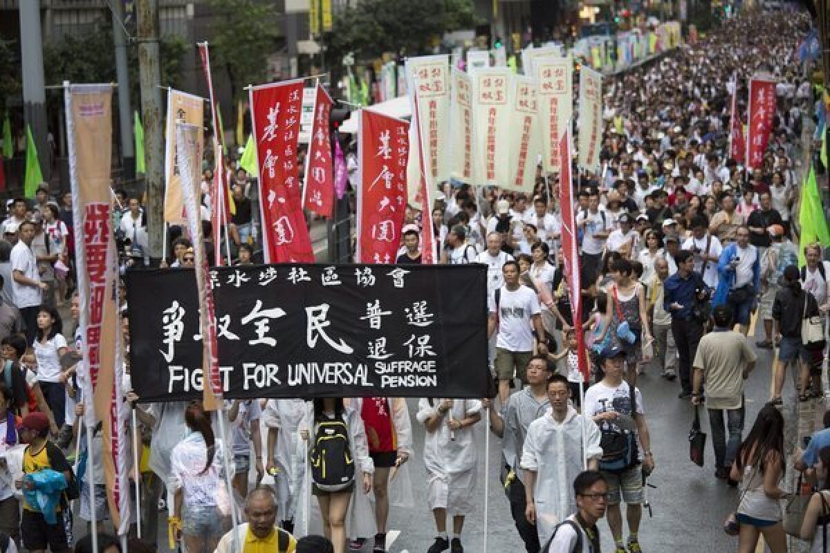 Protesters march during a rally in Hong Kong, calling for "one person, one vote" and universal suffrage in the scheduled 2017 election of a chief executive.