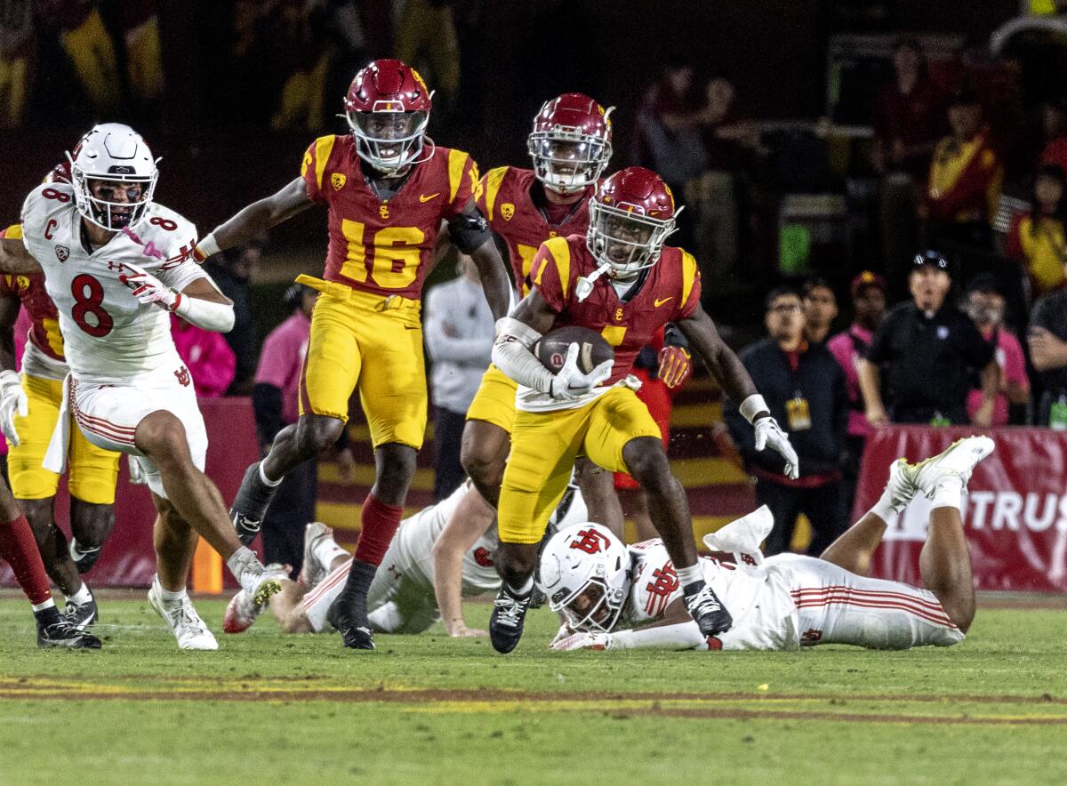 USC receiver Zachariah Branch breaks tackles for a long punt return against Utah at the Coliseum on Oct. 21.