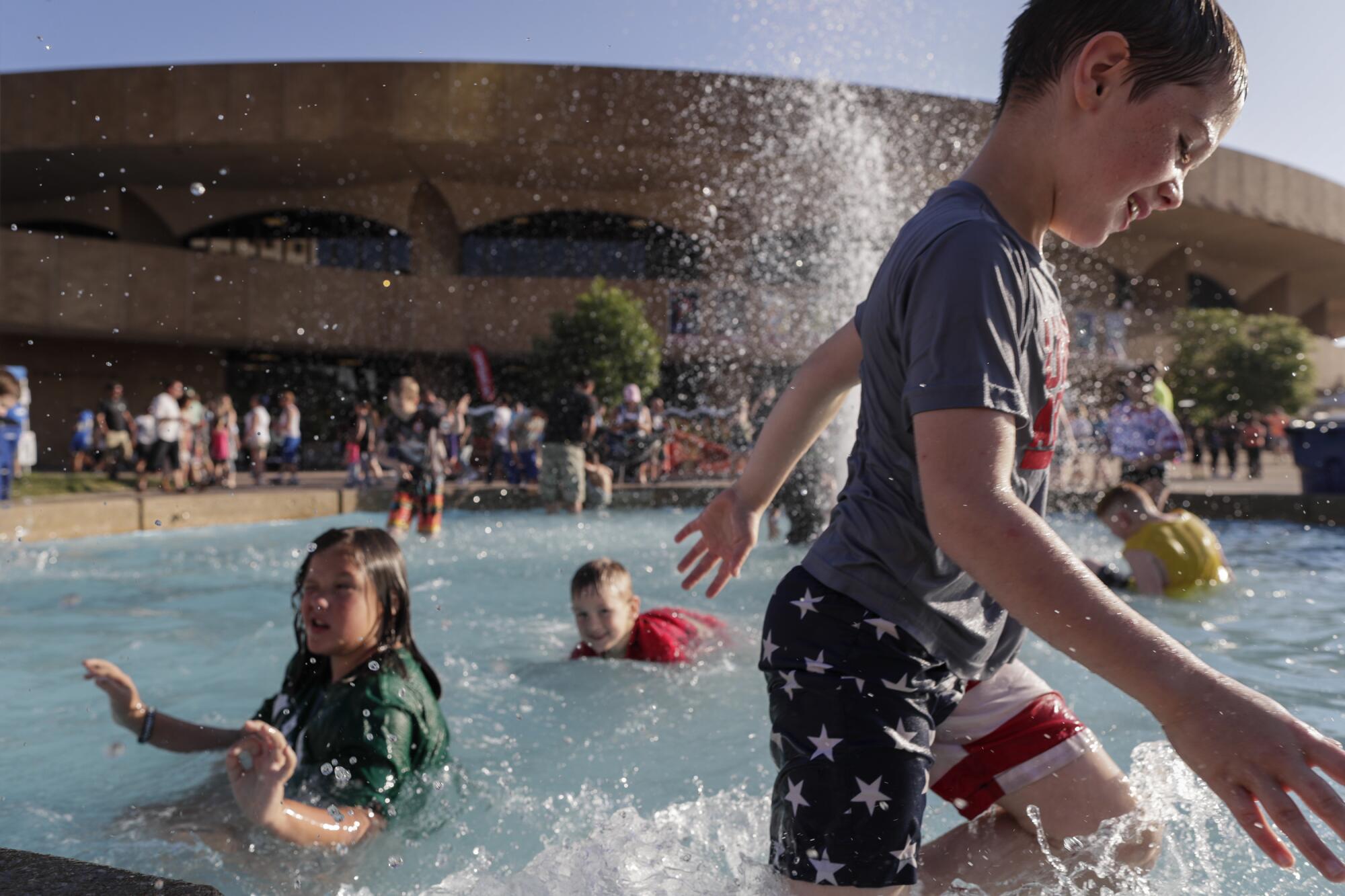 Children frolic in a fountain outside the Century II Performing Arts & Convention Center. 