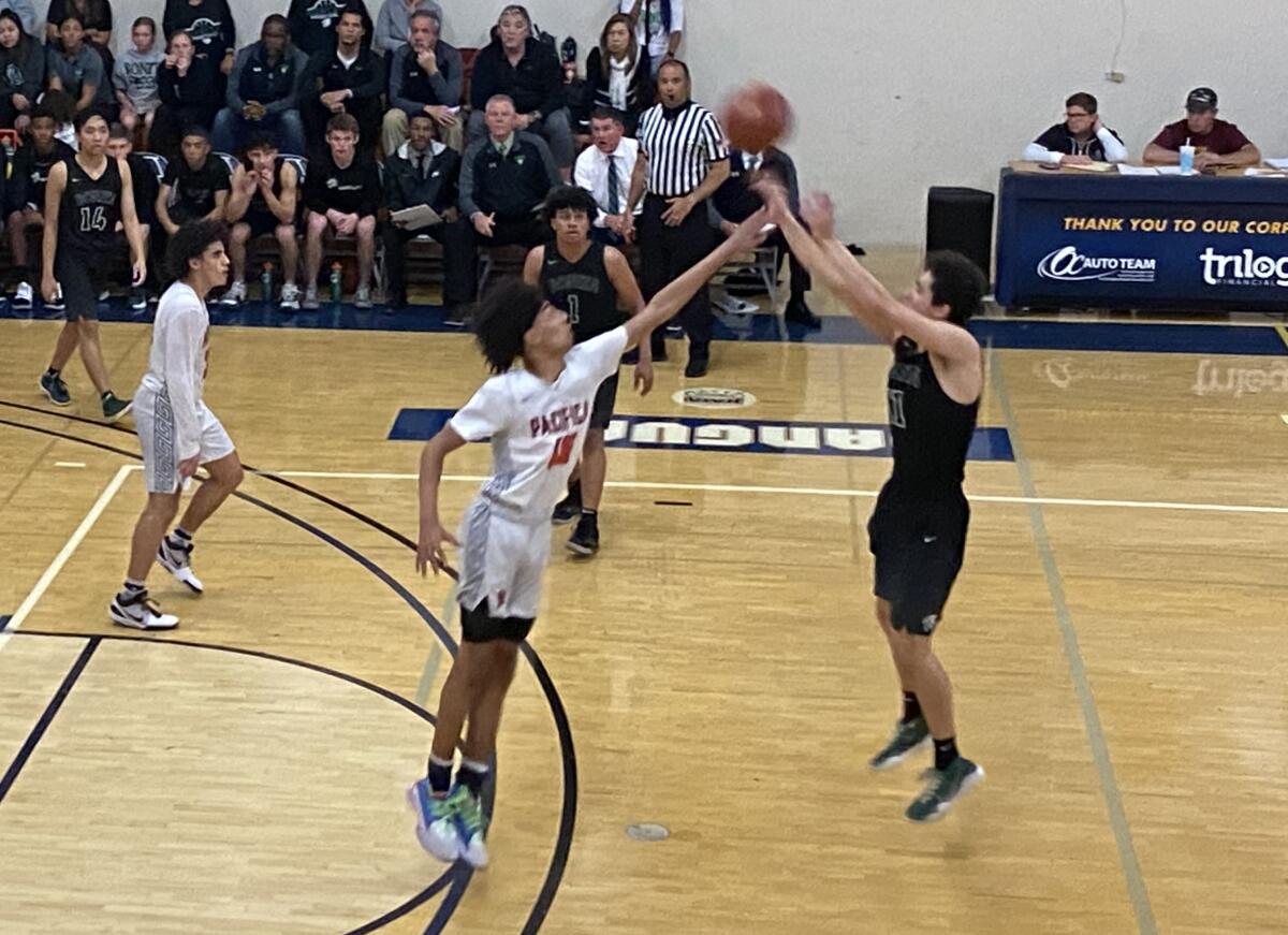 Pacifica Christian Orange County's Houston Mallette defends while Bonita's Gavin Eckler shoots a three-pointer in the third quarter of the CIF Southern Section Division 2A quarterfinal playoff game on Wednesday at Vanguard University.