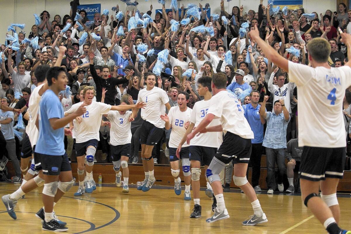 Corona del Mar High celebrates after sweeping Newport Harbor in the Battle of the Bay on Friday night in the Sailors' gym.