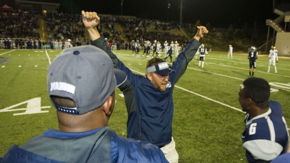 Madison coach Rick Jackson (shown celebrating a past win) guided the Warhawks to a victory over St. Augustine in a game that had been suspended Friday night because of lightning.