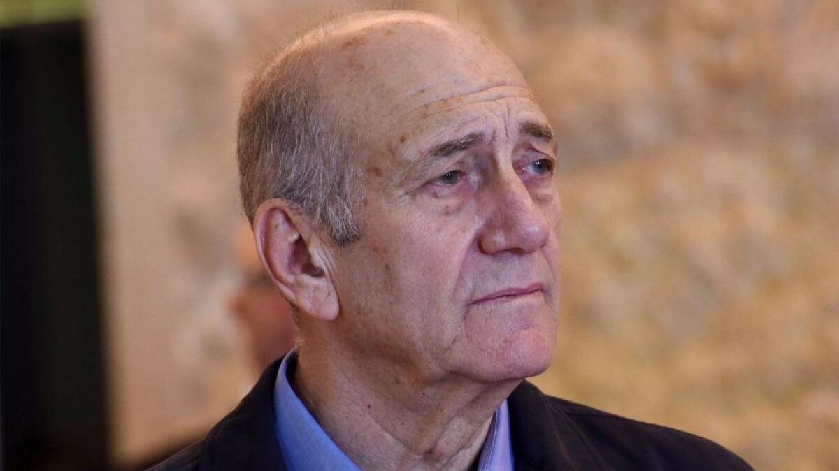 Former Israeli Prime Minister Ehud Olmert leaves the courtroom after the Supreme Court ruled on his appeal in the corruption case in Jerusalem.