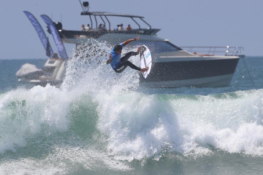 Miguel Pupo of Brazil completes a high air reverse in the U.S. Open of Surfing.