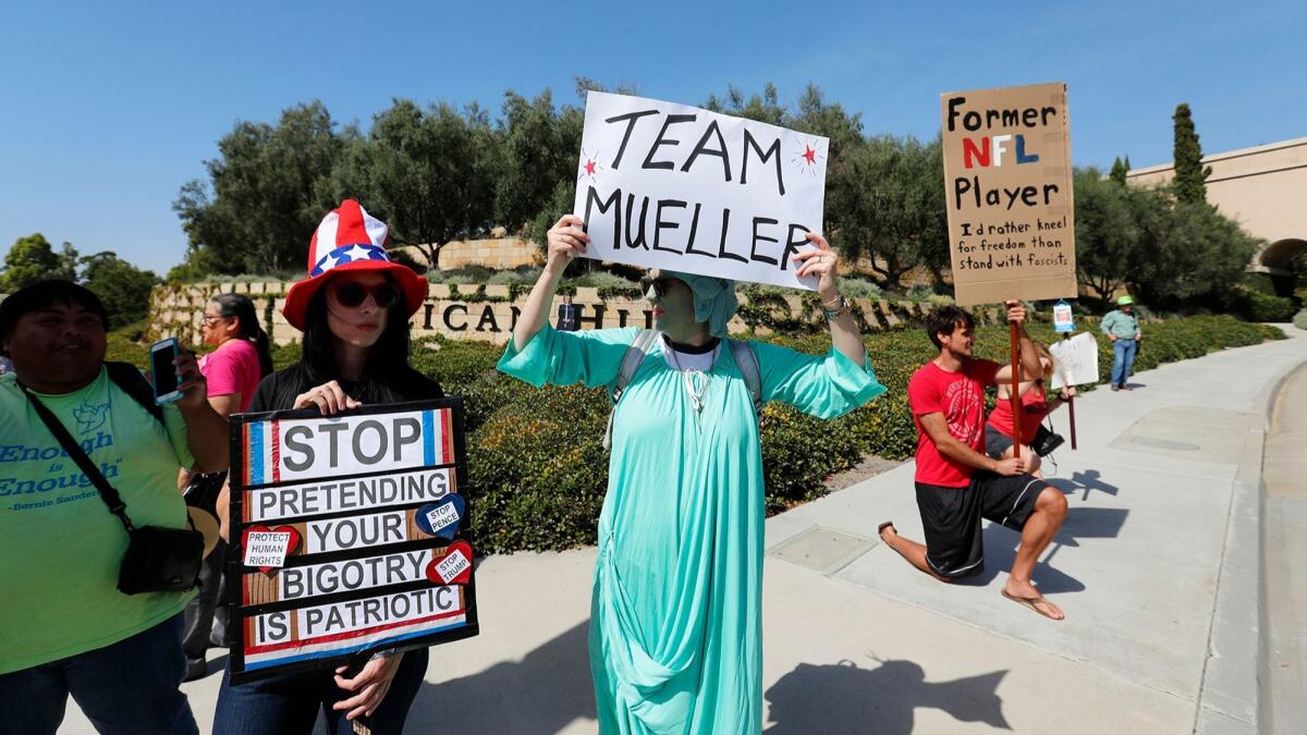Demonstrators protest Monday against Vice President Mike Pence outside the entrance to The Resort at Pelican Hill in Newport Beach, where Pence was attending a Republican congressional fundraiser.