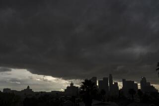 Heavy clouds move over Los Angeles city skyline Saturday, Jan. 23, 2021. Rain and snow showers fell Friday as the first in a series of storms moved through California, marking a major change to real winter weather after weeks of scattershot precipitation that has done little to ease drought. Periods of rain and snow and much cooler temperatures were expected through the weekend, followed in the middle of next week by a potential atmospheric river that could deliver significant rain and snow. (AP Photo/Damian Dovarganes)