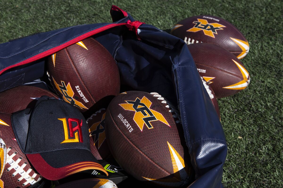 XFL and L.A. Wildcats logos on footballs and hats.