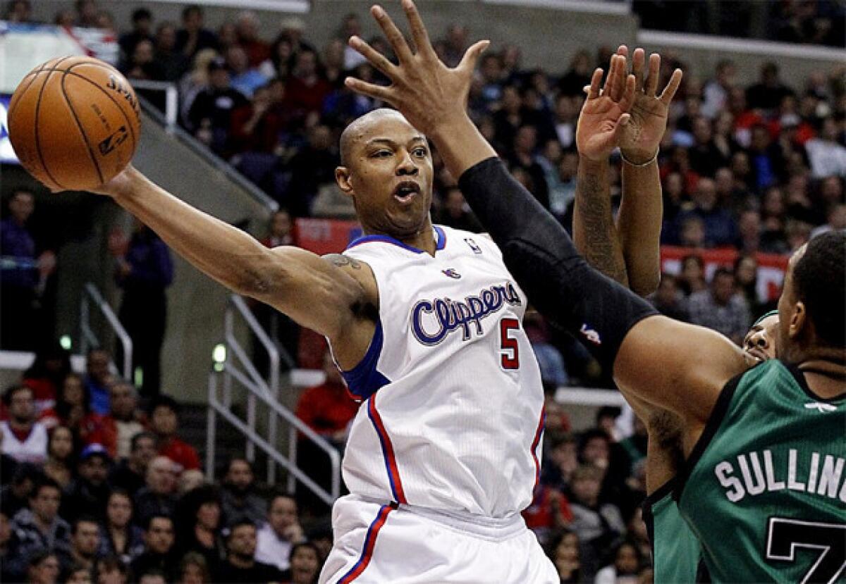 Caron Butler dishes off a pass around Celtics defenders.