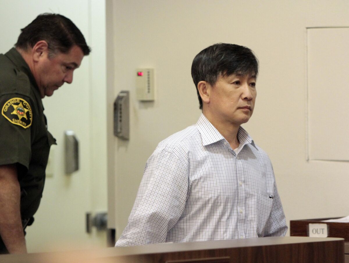 Kwang Chol Joy, shown entering a Santa Ana courtroom Tuesday, was convicted of second-degree murder in the death of his roommate, whose body was dumped in a remote canyon.