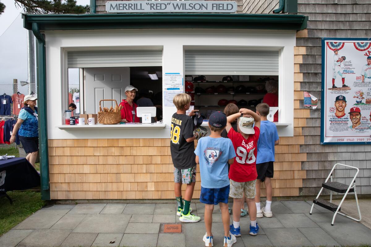 Kids line up at the concession stand at Red Wilson Field during a game earlier this month.