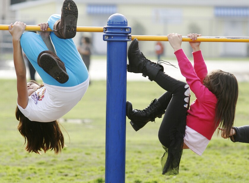 Kids climb on a bar in a playgound at McKinley Elementary School in Burbank in 2012.