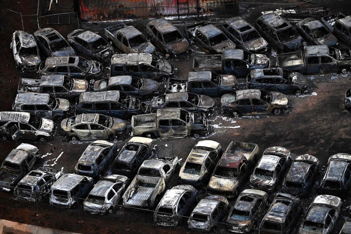 An aerial image shows destroyed cars in Lahaina.