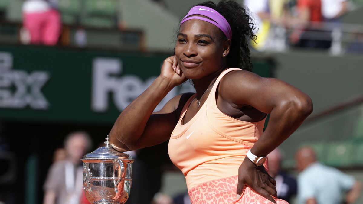 Serena Williams strikes a pose with the championship trophy after defeating Lucie Safarova in the French Open final on June 6, 2015.