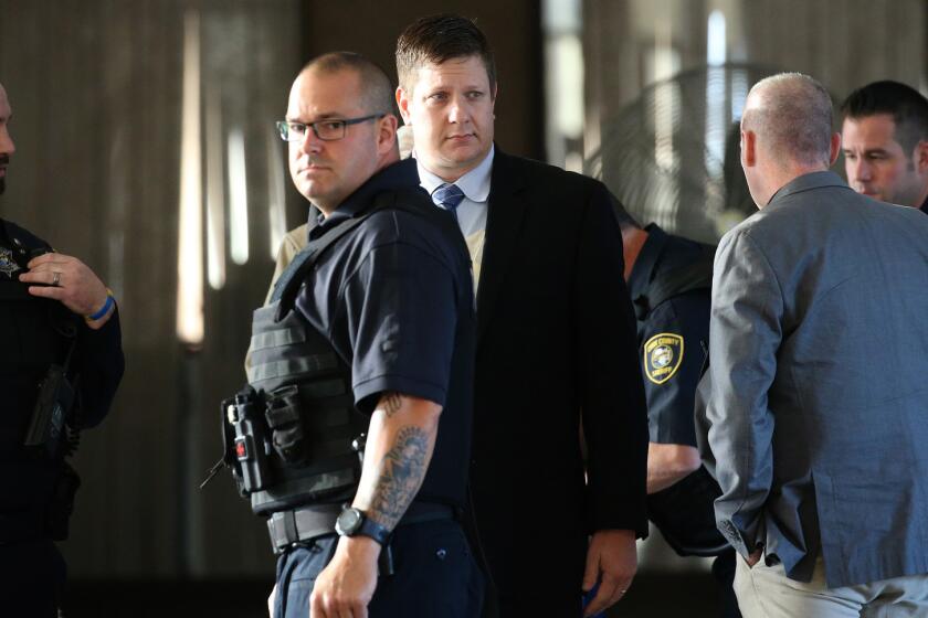 Chicago police Officer Jason Van Dyke, center, arrives for a hearing on Sept. 14, 2018 at the Leighton Criminal Court Building. His attorney announced that a jury will decide his fate.