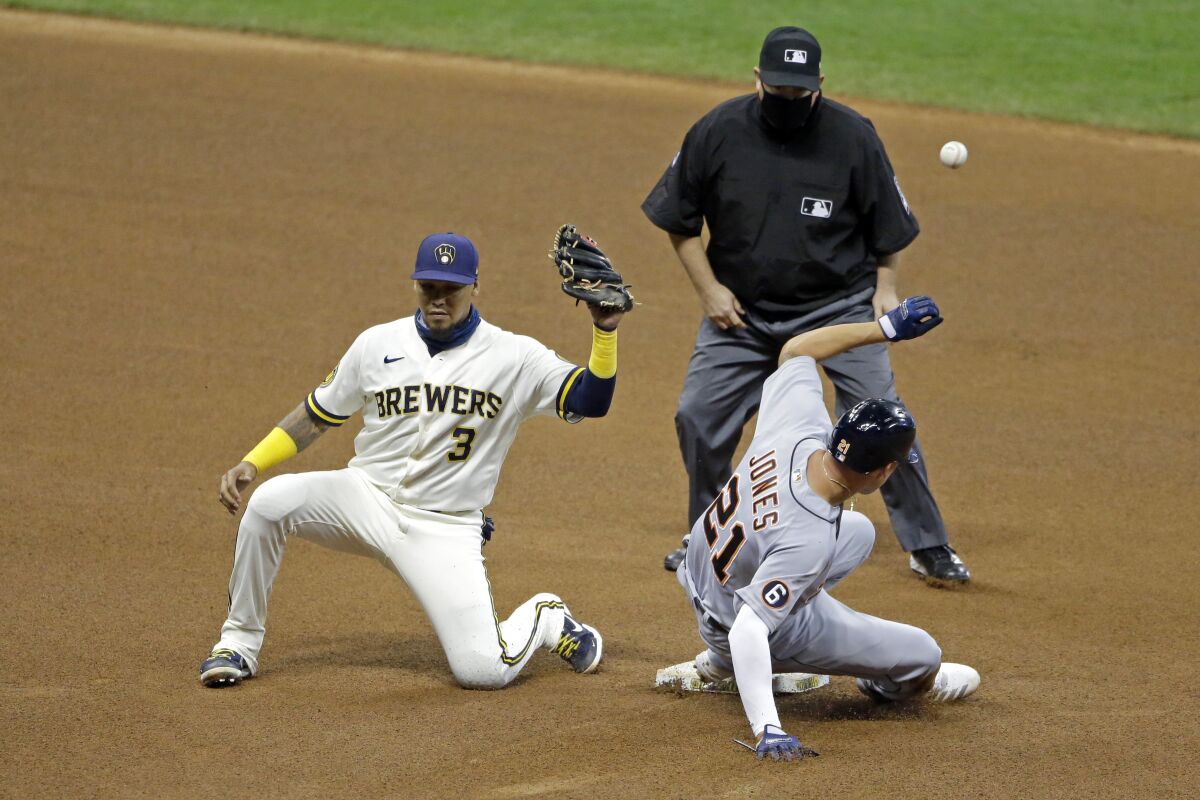 Milwaukee Brewers' Orlando Arcia (3) is unable to control a throw as Detroit Tigers' JaCoby Jones (21) steals second base during the fourth inning of a baseball game Tuesday, Sept. 1, 2020, in Milwaukee. Jones advanced to third base on the play. (AP Photo/Aaron Gash)