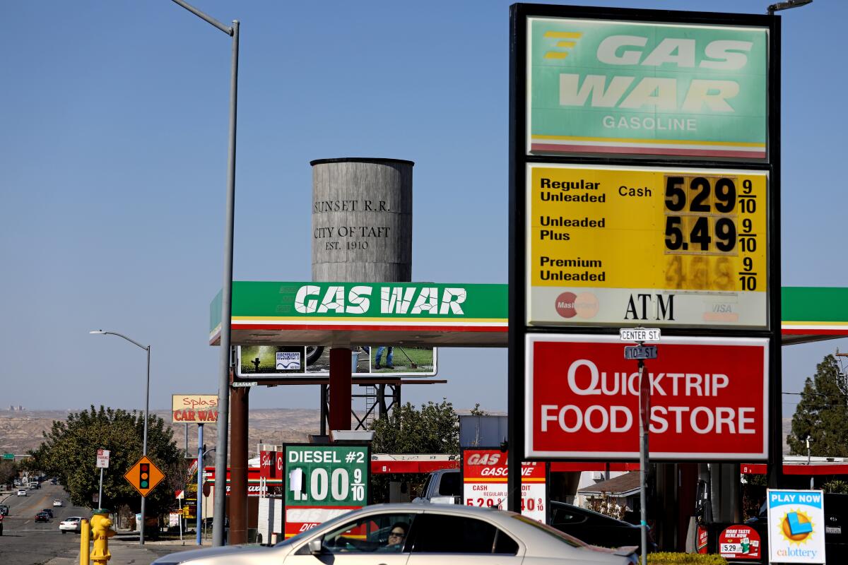 A gas station with a sign and canopy that say "Gas War."
