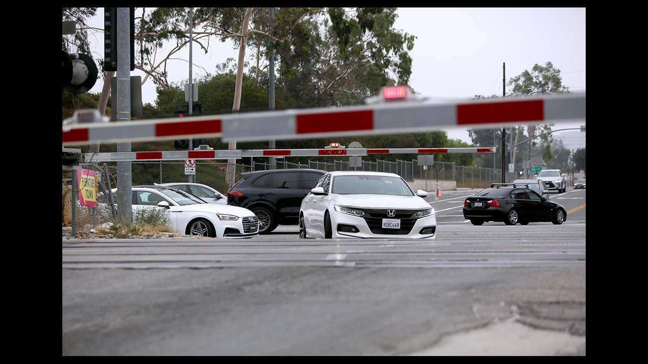 Vehicles wait for a train to pass as Glendale Police motor officers looked for railroad track crossing violators on San Fernando Rd. at Doran in Glendale, on Tuesday morning, Sept. 25, 2018. GPD and Amtrak partnered on Operation Clean Track for Railway Safety Week.